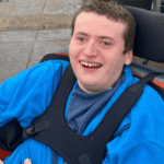 George is 22 and has a rare genetic condition called GRIN2B. He is non-verbal, uses a wheelchair and needs full support with all aspects of daily life. But, as his mum Jane explains, there is much more to him than his diagnosis.